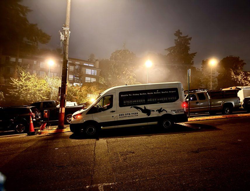 The Island Airporter shuttle parked under the street lights at the Friday Harbor pickup spot before dawn