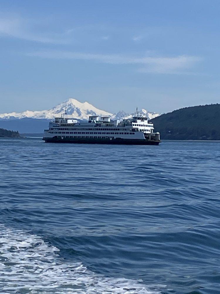 A Washington State ferry crossing the channel with Mount Baker rising behind it