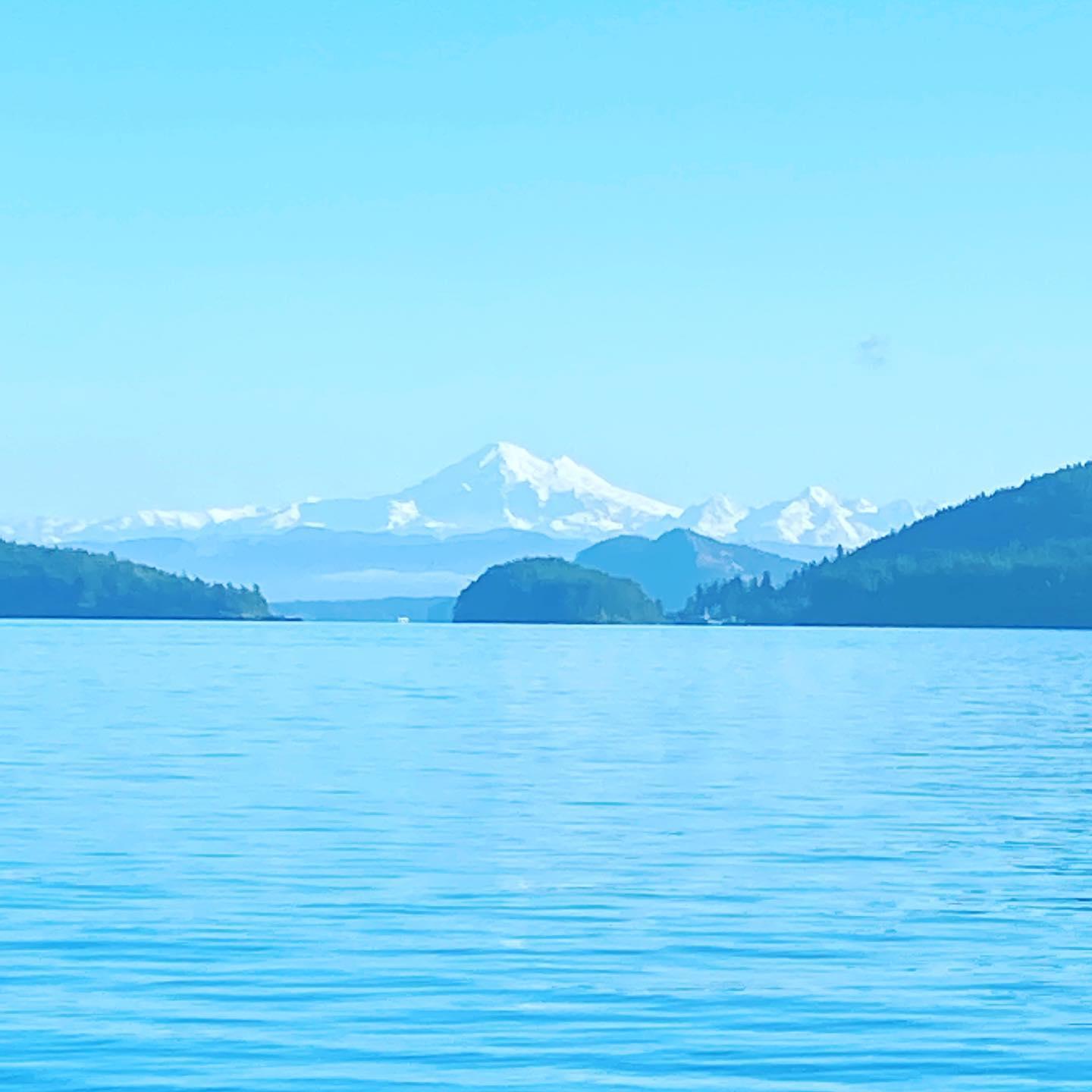 Mount Baker rising over the water and forested islands of the San Juans